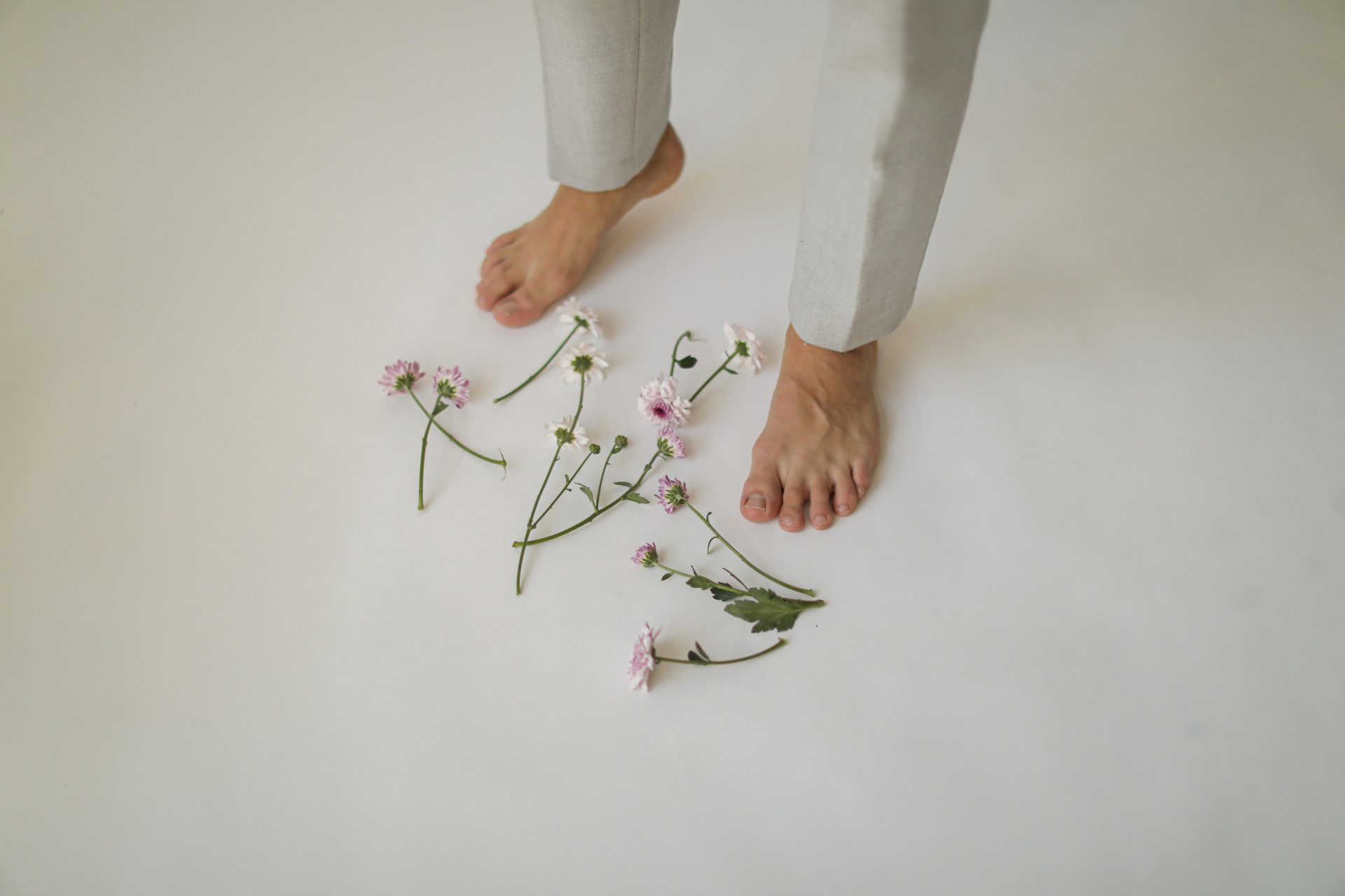 Scattered Flowers on the Floor around the Feet of a Man