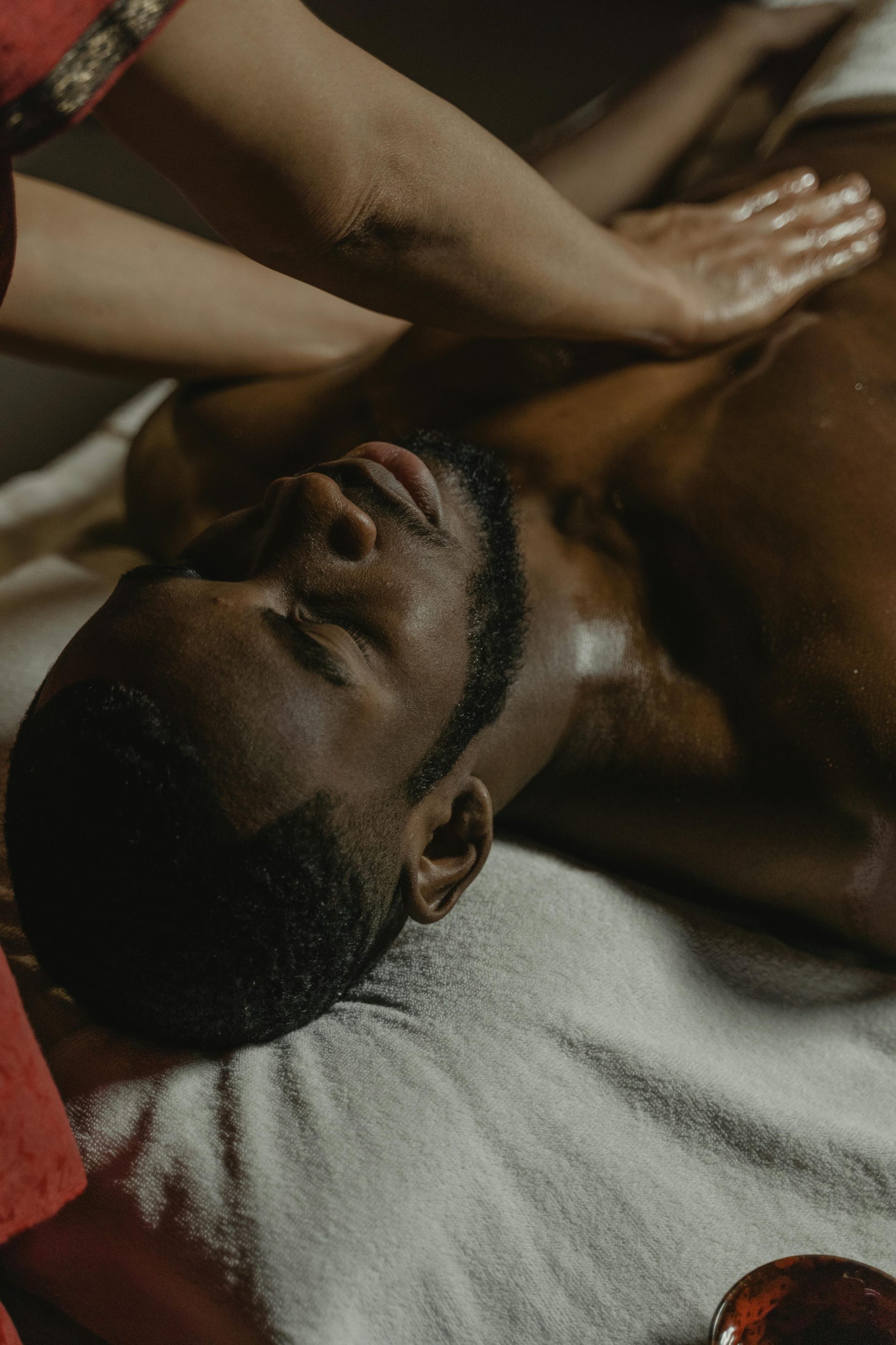 A serene massage therapy session focusing on relaxation and wellness for a man.