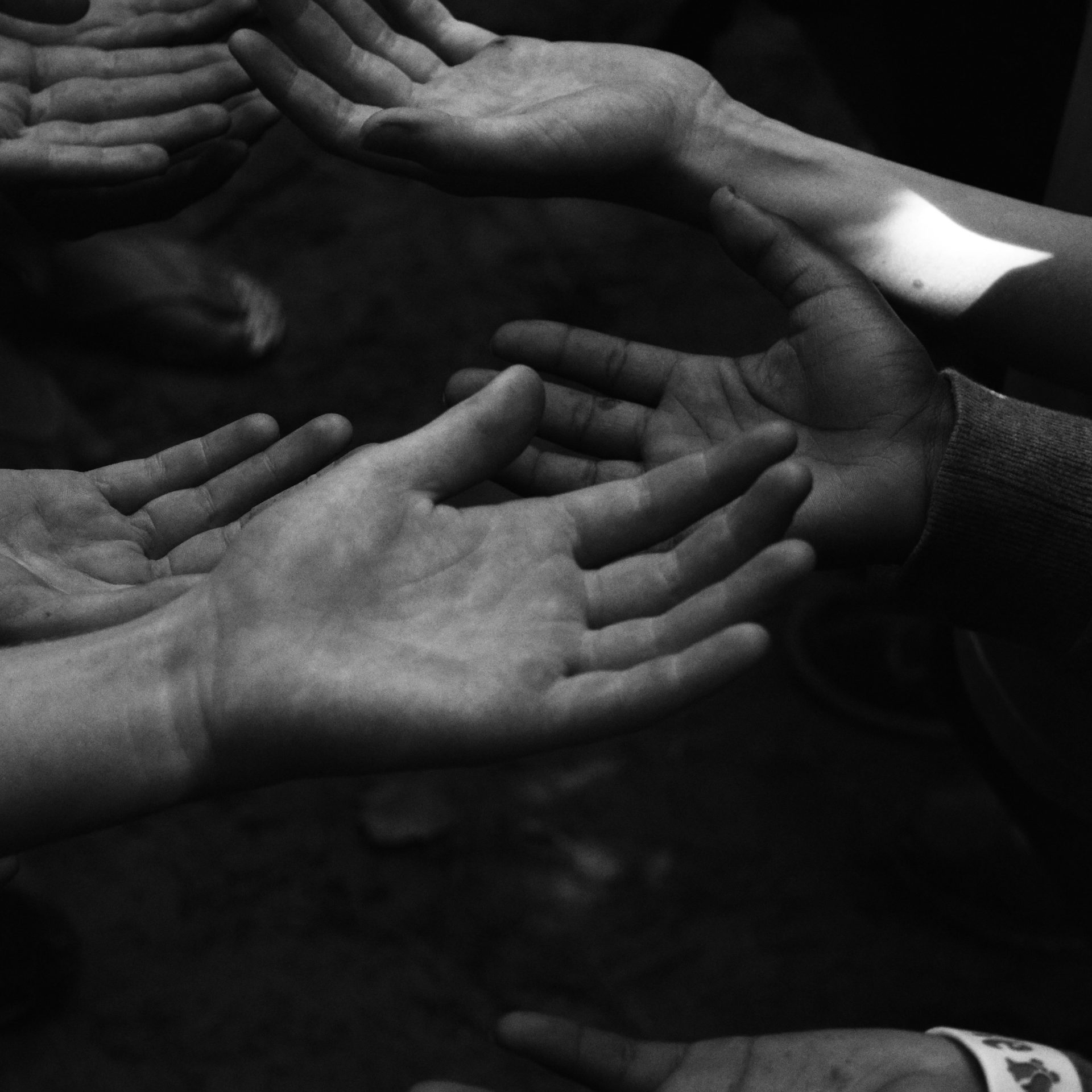 a group of people holding their hands together